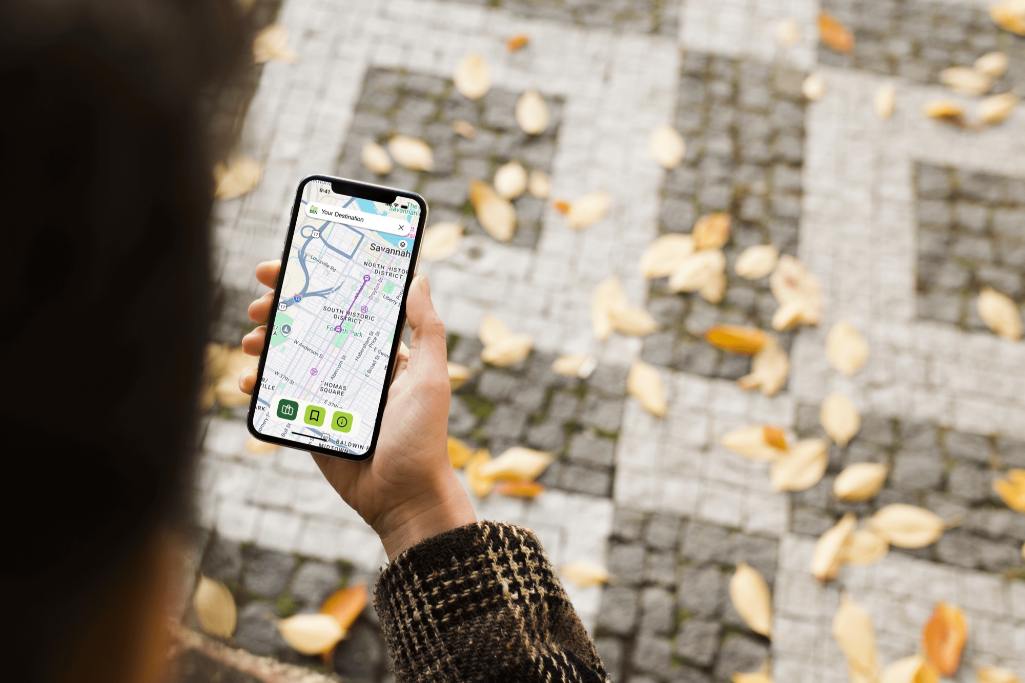 A person holding a phone with the CAT Den map open